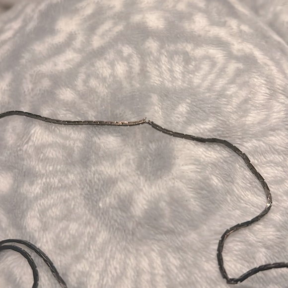 This is a bronze and black looking necklace. - Picture 2 of 5